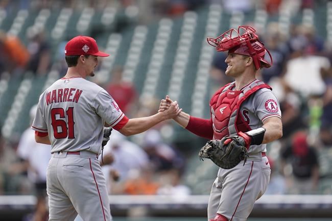 Los Angeles Angels relief pitcher Austin Warren (61) and catcher Max Stassi after the final out in the ninth inning of a baseball game against the Detroit Tigers in Detroit, Thursday, Aug. 19, 2021. The Angels won 13-10. (AP Photo/Paul Sancya)