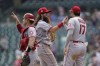 Los Angeles Angels catcher Max Stassi, from left, Brandon Marsh and Shohei Ohtani (17) celebrate after beating the Detroit Tigers 13-10 in a baseball game in Detroit, Thursday, Aug. 19, 2021. (AP Photo/Paul Sancya)