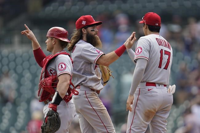 Los Angeles Angels catcher Max Stassi, from left, Brandon Marsh and Shohei Ohtani (17) celebrate after beating the Detroit Tigers 13-10 in a baseball game in Detroit, Thursday, Aug. 19, 2021. (AP Photo/Paul Sancya)