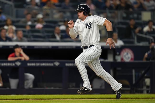 New York Yankees' Luke Voit runs home to score on a sacrifice fly ball by Anthony Rizzo during the third inning of the team's baseball game against the Minnesota Twins on Thursday, Aug. 19, 2021, in New York. (AP Photo/Frank Franklin II)