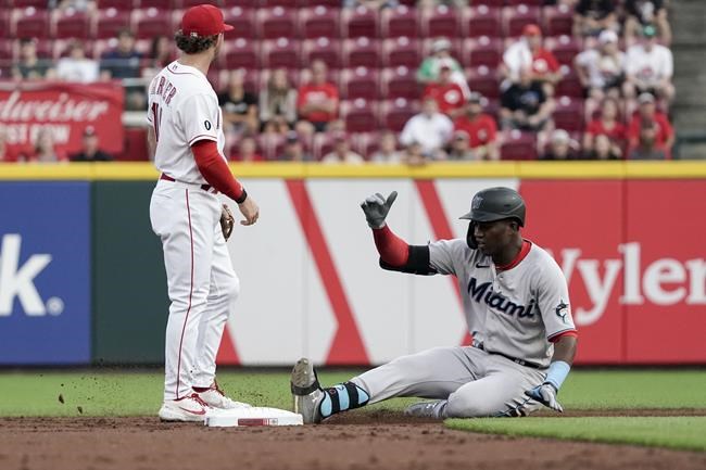 Miami Marlins' Jesus Sanchez slides into second base with a double during the second inning of the team's baseball game against the Cincinnati Reds on Thursday, Aug. 19, 2021, in Cincinnati. (AP Photo/Jeff Dean)