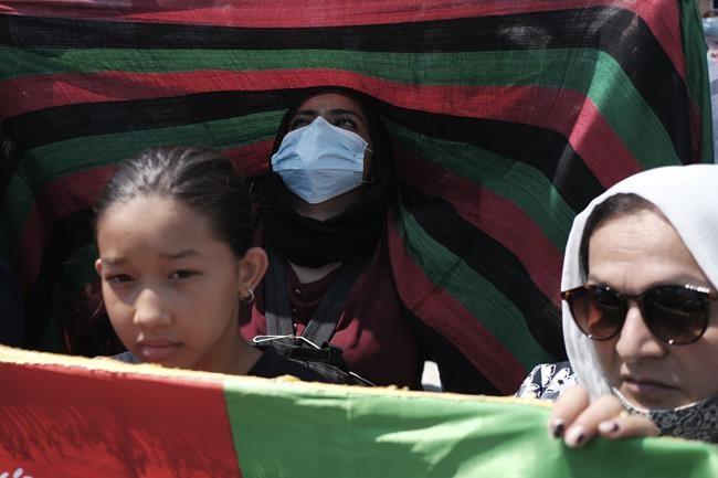 Afghans who live in Greece take part in a rally against the Taliban, in Athens, Thursday, Aug. 19, 2021. A U.N. official warned of dire food shortages in this nation of 38 million people reliant on imports and experts said the country was severely short on cash, highlighting that the Taliban face the same problems as the civilian government they dethroned without the level of international aid it enjoyed. (AP Photo/Aggelos Barai)