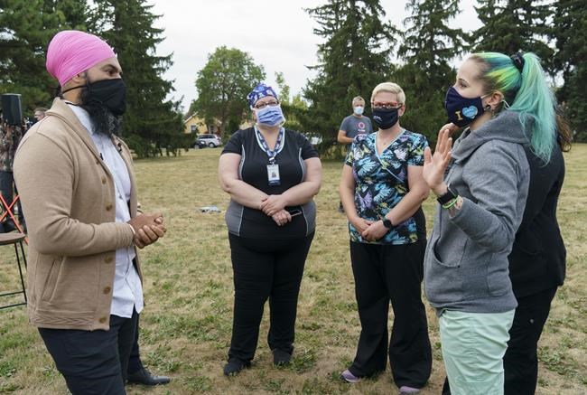 NDP leader Jagmeet Singh chats with health care workers in Edmonton, on Thursday, August 19, 2021. THE CANADIAN PRESS/Paul Chiasson