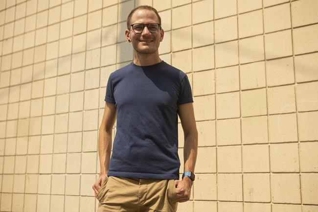 First time voter Justin Fletcher poses for a photo in Toronto, Friday, Aug. 20, 2021. After the voter turnout for youth increased to 57 per cent in the 2015 election the youth turnout rate decreased by 3.2 percentage points in 2019, which raises concerns of a further drop this year, especially after Elections Canada decided not to offer vote on campus during this election. THE CANADIAN PRESS/Chris Young