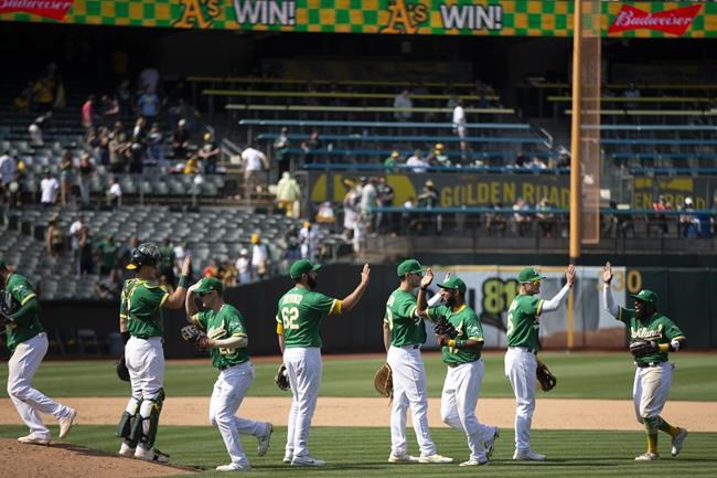 Oakland Athletics players celebrate their victory over the Texas Rangers in a baseball game, Sunday, Aug. 8, 2021, in Oakland, Calif. (AP Photo/D. Ross Cameron)