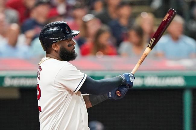 Cleveland Indians' Franmil Reyes watches his two-run single during the sixth inning of a baseball game against the Los Angeles Angels, Friday, Aug. 20, 2021, in Cleveland. (AP Photo/Tony Dejak)