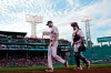 Boston Red Sox starting pitcher Chris Sale, far left, walks from the bullpen with catcher Christian Vazquez before a baseball game against the Texas Rangers at Fenway Park, Friday, Aug. 20, 2021, in Boston. (AP Photo/Elise Amendola)