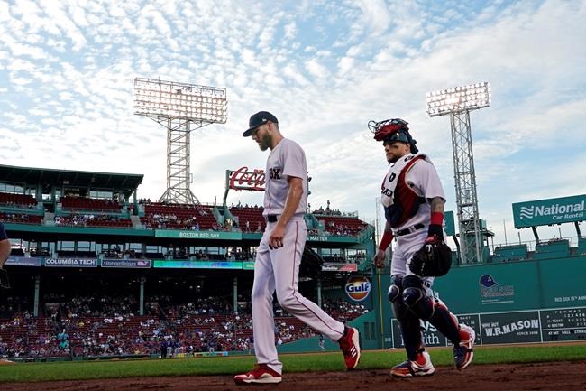 Boston Red Sox starting pitcher Chris Sale, far left, walks from the bullpen with catcher Christian Vazquez before a baseball game against the Texas Rangers at Fenway Park, Friday, Aug. 20, 2021, in Boston. (AP Photo/Elise Amendola)