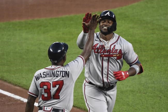 Atlanta Braves' Jorge Soler is greeted by third base coach Ron Washington (37) after hitting a solo home run during the third inning off Baltimore Orioles starting pitcher Keegan Akin during a baseball game Friday, Aug. 20, 2021, in Baltimore. (AP Photo/Terrance Williams)