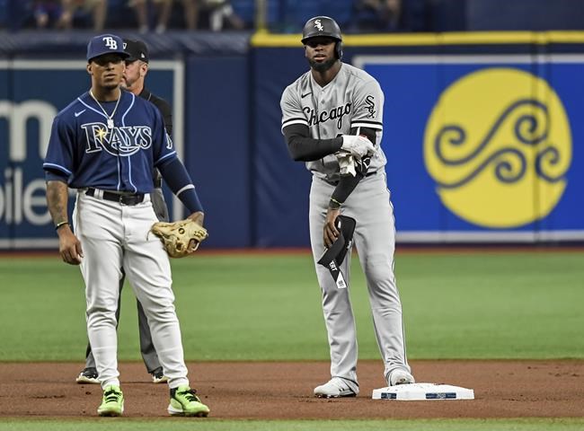 Tampa Bay Rays' Wander Franco, left, waits as Chicago White Sox's Luis Robert stands on second base after hitting an RBI double during the first inning of a baseball game Friday, Aug. 20, 2021, in St. Petersburg, Fla. (AP Photo/Steve Nesius)