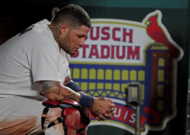 St. Louis Cardinals catcher Yadier Molina sits on the bench after grounding out in the eighth inning of the team's baseball game against the Pittsburgh Pirates, Friday, Aug. 20, 2021, in St. Louis. (AP Photo/Tom Gannam)