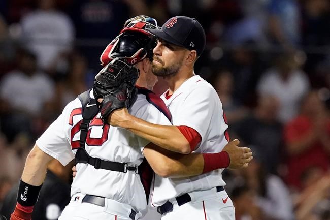 Boston Red Sox closer Matt Barnes, right, hugs catcher Kevin Plawecki after they defeated the Texas Rangers in a baseball game at Fenway Park, Friday, Aug. 20, 2021, in Boston. (AP Photo/Elise Amendola)