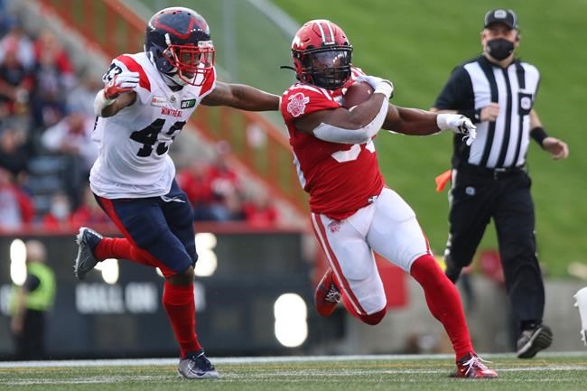 Montreal Alouettes' Alesandre Chervier chases Calgary Stampeders' KaDeem Carey during first half CFL football action in Calgary, Friday, Aug. 20, 2021. THE CANADIAN PRESS/David Chidley