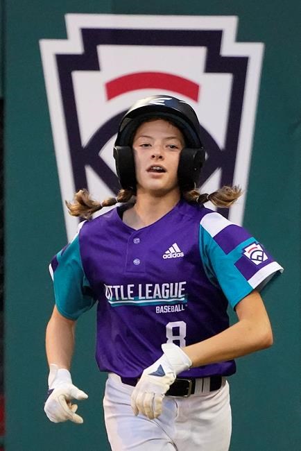Abilene, Texas' Ella Bruning runs back to the dugout after scoring on a wild pitch by Sammamish, Wash., starting pitcher Sanath Chari during the second inning of a baseball game at the Little League World Series in South Williamsport, Pa., Friday, Aug. 20, 2021. (AP Photo/Gene J. Puskar)