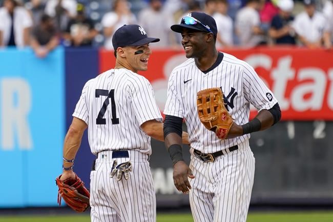 New York Yankees' Andrew Velazquez (71) celebrates with Estevan Forial after they defeated the Minnesota Twins in a baseball game, Saturday, Aug. 21, 2021, in New York. (AP Photo/Mary Altaffer)