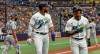 Tampa Bay Rays' Yandy Diaz, center, and Wander Cruz head for the dugout after scoring on an RBI-double hit by Brandon Lowe off Chicago White Sox starter Dallas Keuchel during the first inning of a baseball game, Saturday, Aug. 21, 2021, in St. Petersburg, Fla. (AP Photo/Steve Nesius)