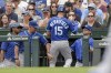 Kansas City Royals' Whit Merrifield (15) enters the dugout after scoring on wild pitch against the Chicago Cubs during the first inning of a baseball game Saturday, Aug. 21, 2021, in Chicago. (AP Photo/Mark Black)