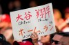 A fan of Los Angeles Angels' Shohei Ohtani holds up a sign during the sixth inning of the Angels' baseball game against the Cleveland Indians, Saturday, Aug. 21, 2021, in Cleveland. (AP Photo/Tony Dejak)