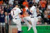 Houston Astros' Yordan Alvarez, right, celebrates with Carlos Correa (1) after both scored on Alvarez's three-run home run against the Seattle Mariners during the third inning of a baseball game Saturday, Aug. 21, 2021, in Houston. (AP Photo/David J. Phillip)