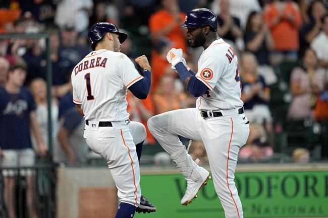 Houston Astros' Yordan Alvarez, right, celebrates with Carlos Correa (1) after both scored on Alvarez's three-run home run against the Seattle Mariners during the third inning of a baseball game Saturday, Aug. 21, 2021, in Houston. (AP Photo/David J. Phillip)