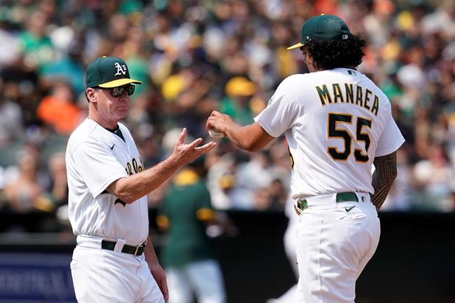 Oakland Athletics starting pitcher Sean Manaea (55) hands the ball to manager Bob Melvin as he is taken out for a relief pitcher during the fifth inning of the team's baseball game against the San Francisco Giants in Oakland, Calif., Saturday, Aug. 21, 2021. (AP Photo/Jeff Chiu)