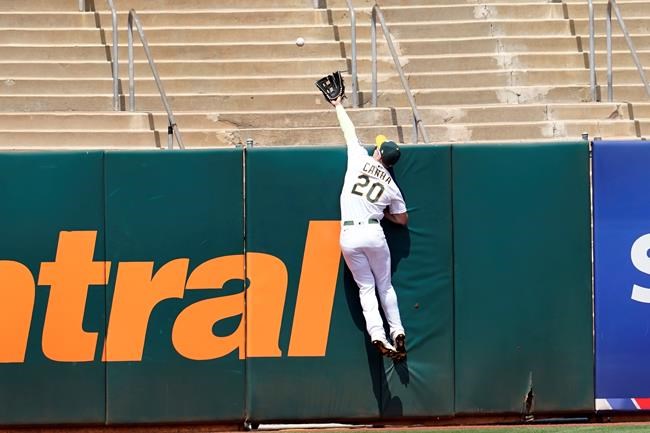Oakland Athletics left fielder Mark Canha cannot catch a two-run home run hit by San Francisco Giants' Kris Bryant during the second inning of a baseball game in Oakland, Calif., Saturday, Aug. 21, 2021. (AP Photo/Jeff Chiu)