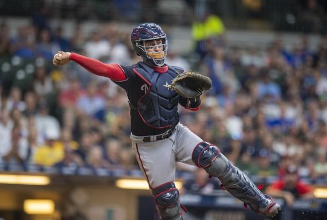 Washington Nationals catcher Tres Barrera throws out a Milwaukee Brewers batter in the bottom of the fifth inning of a baseball game Saturday, Aug. 21, 2021, in Milwaukee. (AP Photo/Michael R. Schmidt)