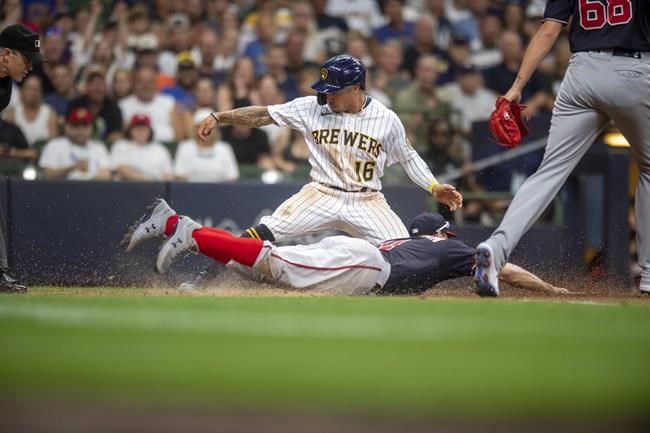 Milwaukee Brewers' Kolten Wong (16) scores during the fifth inning of the team's baseball game against the Washington Nationals, Saturday, Aug. 21, 2021, in Milwaukee. (AP Photo/Michael R. Schmidt)
