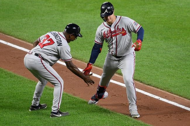 Atlanta Braves' Joc Pederson, right, celebrates his home run with third base coach Ron Washington during the fourth inning of the team's baseball game against the Baltimore Orioles, Saturday, Aug. 21, 2021, in Baltimore. (AP Photo/Nick Wass)