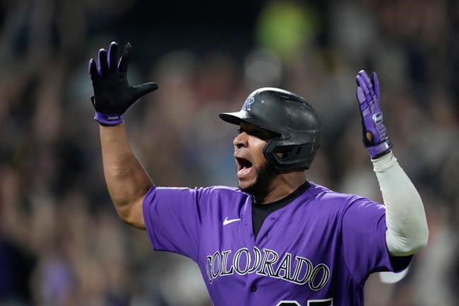 Colorado Rockies' Elias Diaz celebrates his game-ending, three-run home run off Arizona Diamondbacks relief pitcher J.B. Wendelken during the ninth inning of a baseball game Saturday, Aug. 21, 2021, in Denver. The Rockies won 5-2. (AP Photo/David Zalubowski)