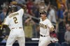 San Diego Padres' Adam Frazier, right, celebrates with Trent Grisham after scoring on a wild pitch during the 10th inning of the team's baseball game against the Philadelphia Phillies, Saturday, Aug. 21, 2021, in San Diego. (AP Photo/Gregory Bull)