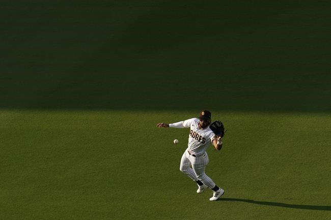 San Diego Padres right fielder Fernando Tatis Jr. fields a hit for a single by Philadelphia Phillies' Bryce Harper during the first inning of a baseball game Saturday, Aug. 21, 2021, in San Diego. (AP Photo/Gregory Bull)