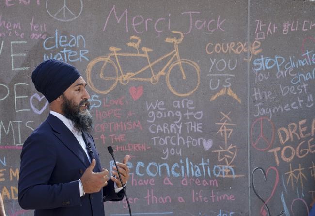 NDP Leader Jagmeet Singh responds to questions in front of a Jack Layton memorial wall in Toronto on Sunday, August 22, 2021. THE CANADIAN PRESS/Paul Chiasson