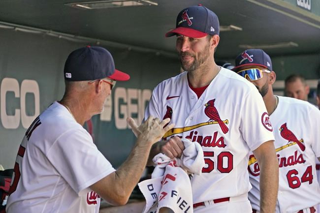 St. Louis Cardinals starting pitcher Adam Wainwright (50) is congratulated by pitching coach Mike Maddux after being removed during the eighth inning of a baseball game against the Pittsburgh Pirates Sunday, Aug. 22, 2021, in St. Louis. (AP Photo/Jeff Roberson)