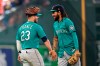 Seattle Mariners' Ty France (23) and J.P. Crawford celebrate after a baseball game against the Houston Astros Sunday, Aug. 22, 2021, in Houston. The Mariners won 6-3 in 11 innings. (AP Photo/David J. Phillip)