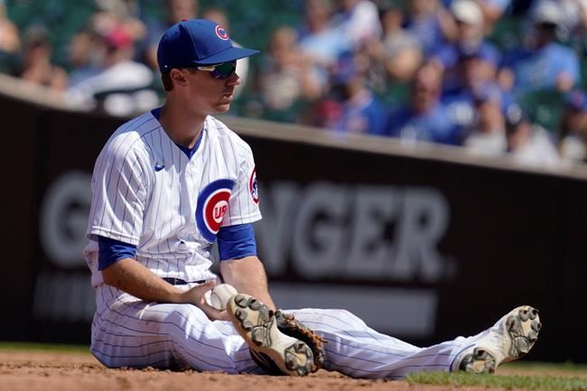 Chicago Cubs second baseman Matt Duffy sits on the field after Kansas City Royals' Andrew Benintendi hit a two-run double in the third inning of a baseball game Sunday, Aug. 22, 2021, in Chicago. (AP Photo/Nam Y. Huh)