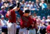 Arizona Diamondbacks' Josh VanMeter, left, congratulates Daulton Varsho who crosses home plate after hitting a three-run home run off Colorado Rockies starting pitcher Jon Gray in the second inning of a baseball game Sunday, Aug. 22, 2021, in Denver. (AP Photo/David Zalubowski)