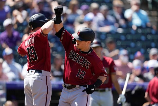 Arizona Diamondbacks' Josh VanMeter, left, congratulates Daulton Varsho who crosses home plate after hitting a three-run home run off Colorado Rockies starting pitcher Jon Gray in the second inning of a baseball game Sunday, Aug. 22, 2021, in Denver. (AP Photo/David Zalubowski)