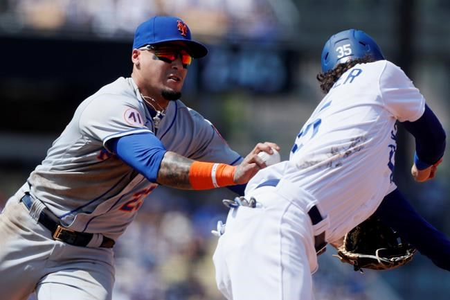 New York Mets shortstop Javier Baez, left, tags out Los Angeles Dodgers' Cody Bellinger on a steal-attempt during the fourth inning of a baseball game in Los Angeles, Sunday, Aug. 22, 2021. (AP Photo/Alex Gallardo)