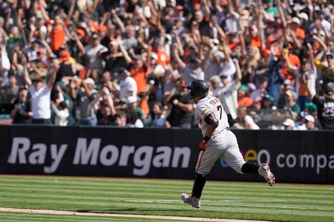 San Francisco Giants' Donovan Solano rounds the bases after hitting a two-run home run against the Oakland Athletics during the eighth inning of a baseball game in Oakland, Calif., Sunday, Aug. 22, 2021. (AP Photo/Jeff Chiu)