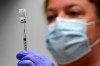 FILE - In this March 2, 2021, file photo, pharmacy technician Hollie Maloney loads a syringe with Pfizer's COVID-19 vaccine at the Portland Expo in Portland, Maine. The U.S. gave full approval to Pfizer's COVID-19 vaccine on Monday, Aug. 23, 2021. (AP Photo/Robert F. Bukaty, File)