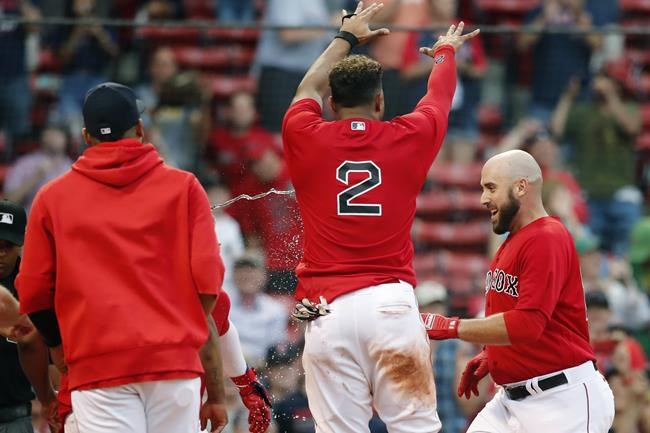 Boston Red Sox's Xander Bogaerts (2) celebrates as Travis Shaw, right, crosses home plate on his walkoff grand slam during the 11th inning of a baseball game against the Texas Rangers, Monday, Aug. 23, 2021, in Boston. (AP Photo/Michael Dwyer)