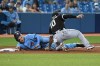 Toronto Blue Jays' Reese McGuire, left, is tagged out at third base by Chicago White Sox's Yoan Moncada (10) in the sixth inning of an American League baseball game in Toronto on Monday, Aug. 23, 2021. THE CANADIAN PRESS/Jon Blacker