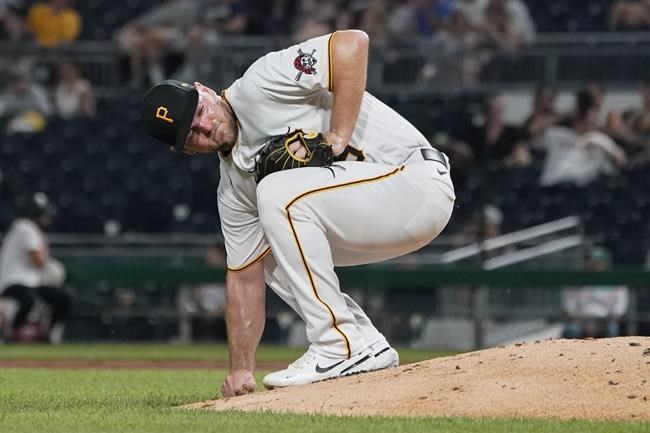 Pittsburgh Pirates starting pitcher Wil Crowe picks up dirt behind the mound after giving up a hit to Arizona Diamondbacks' Ketel Martels that drove in a run in the fifth inning of a baseball game, Monday, Aug. 23, 2021, in Pittsburgh. (AP Photo/Keith Srakocic)