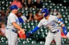 Kansas City Royals' Whit Merrifield (15) celebrates with third base coach Vance Wilson after hitting a two-run triple against the Houston Astros during the eighth inning of a baseball game Monday, Aug. 23, 2021, in Houston. (AP Photo/David J. Phillip)
