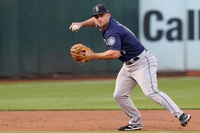Seattle Mariners third baseman Kyle Seager throws out Oakland Athletics' Josh Harrison at first base during the second inning of a baseball game in Oakland, Calif., Monday, Aug. 23, 2021. (AP Photo/Jeff Chiu)