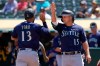 Seattle Mariners' Abraham Toro, left, celebrates with Kyle Seager after both scored on a two-run single by Luis Torrens during the third inning of a baseball game against the Oakland Athletics in Oakland, Calif., Tuesday, Aug. 24, 2021. (AP Photo/Jeff Chiu)