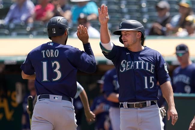 Seattle Mariners' Abraham Toro, left, celebrates with Kyle Seager after both scored on a two-run single by Luis Torrens during the third inning of a baseball game against the Oakland Athletics in Oakland, Calif., Tuesday, Aug. 24, 2021. (AP Photo/Jeff Chiu)