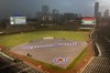 Weather warnings are posted on the left and right field scoreboards as several thunderstorms descending into the Wrigley Field area have forced the postponement of a baseball game between the Chicago Cubs and the Colorado Rockies Tuesday, Aug. 24, 2021, in Chicago. The game was rescheduled as part of a split doubleheader Wednesday. (AP Photo/Charles Rex Arbogast)
