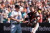 San Francisco Giants pitcher Jake McGee, left, celebrates with catcher Buster Posey after they defeated the Oakland Athletics in a baseball game in Oakland, Calif., Sunday, Aug. 22, 2021. (AP Photo/Jeff Chiu)
